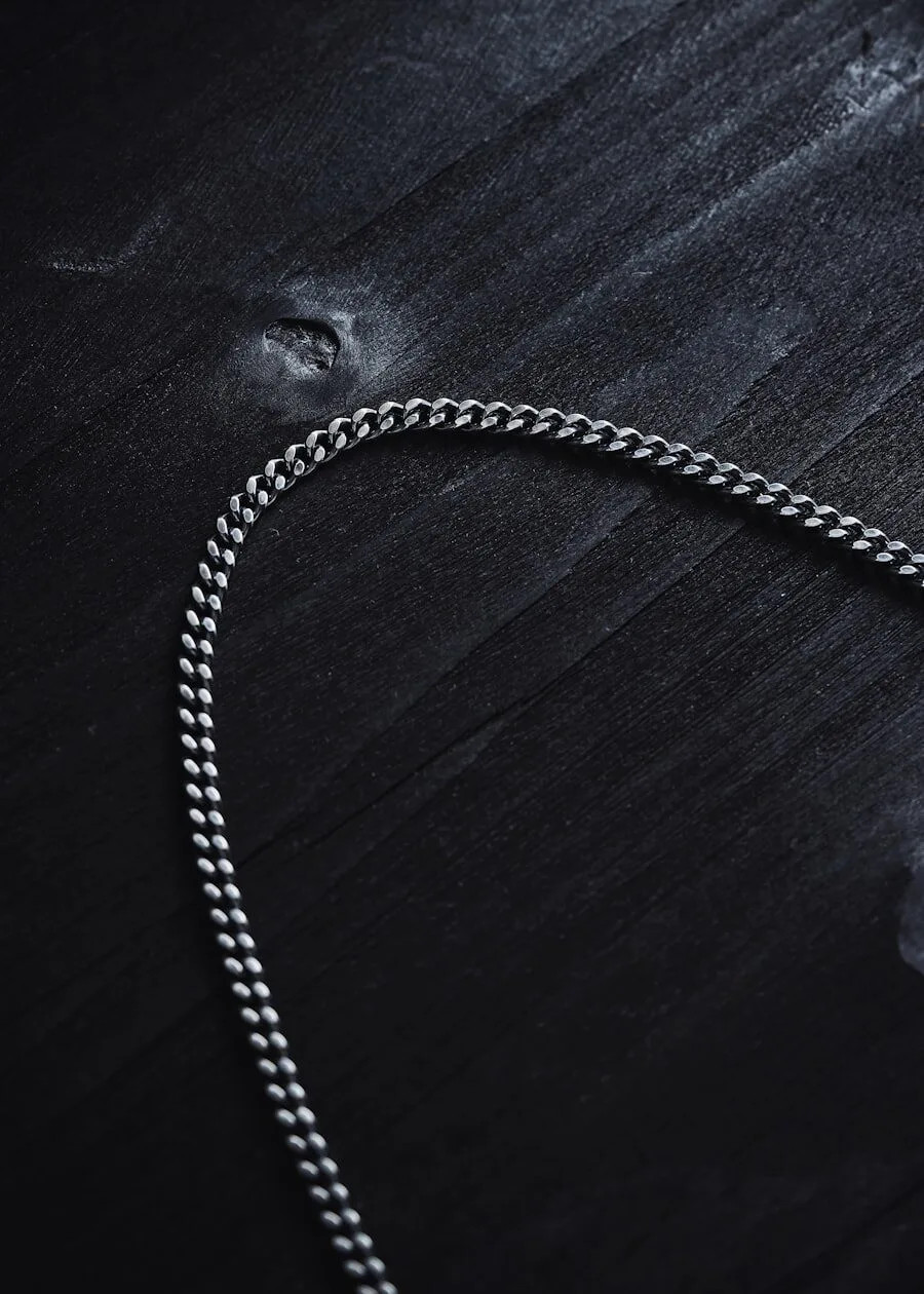 Heavy silver chain on dark surface